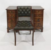 20th century mahogany desk with green tooled leather inset top above the shaped front, nine assorted