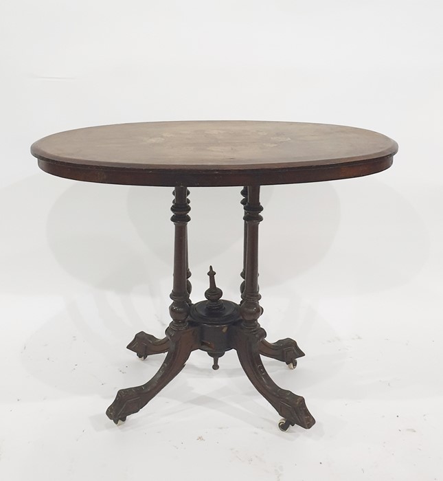Early Victorian oval loo table with inlaid top above the four central turned columns uniting to