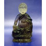 Chinese carved rock crystal figure of seated Buddha on lotus flower, 9.5cm highCondition ReportThe