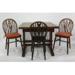 Early 20th century oak two door sideboard, extending rectangular dining table and three wheel back