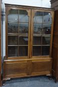 Late 19th/early 20th century mahogany bookcase with astragal glazed door enclosing shelves, two