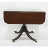 19th century mahogany Pembroke table on single pedestal to four reeded swept legs, brass caps and