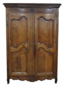 Continental armoire, the moulded pediment above carved frieze, two panelled doors and shaped