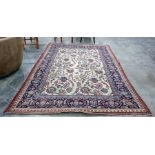 Cream ground Eastern rug, the central field with allover foliate decoration, on a blue ground,