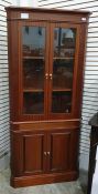 20th century mahogany corner display cabinet, two glazed doors enclosing three shelves all on a base