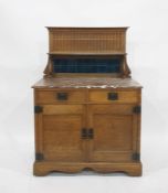 Early 20th century Arts & Crafts-style washstand, the oak back with blue tiles, marble topped