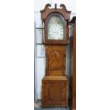 English long cased clock of broad proportions with brightly painted dial by Rutherford of