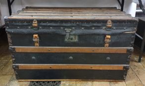 Wooden batoned black leather and studded steamer-type trunk, either end emblazoned with the initials