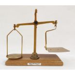 Set of brass postal scales on mahogany base with weights