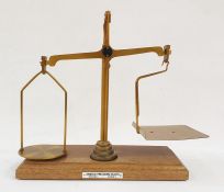 Set of brass postal scales on mahogany base with weights