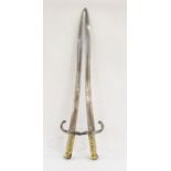 Two 19th century French chassepot bayonets dated 1872 and 1869 and brass drummer's badge (3)