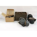 Three assorted gas masks, belts and ammunition tin