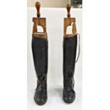 Pair of black leather riding boots with wooden trees