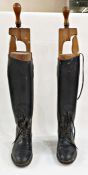 Pair of black leather riding boots with wooden trees