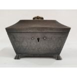 White metal sarcophagus-shaped box, the top with brass ring handle and opening to reveal red