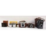 Five assorted cameras to include VP Twin bakelite pocket camera in original box, Kodak 104