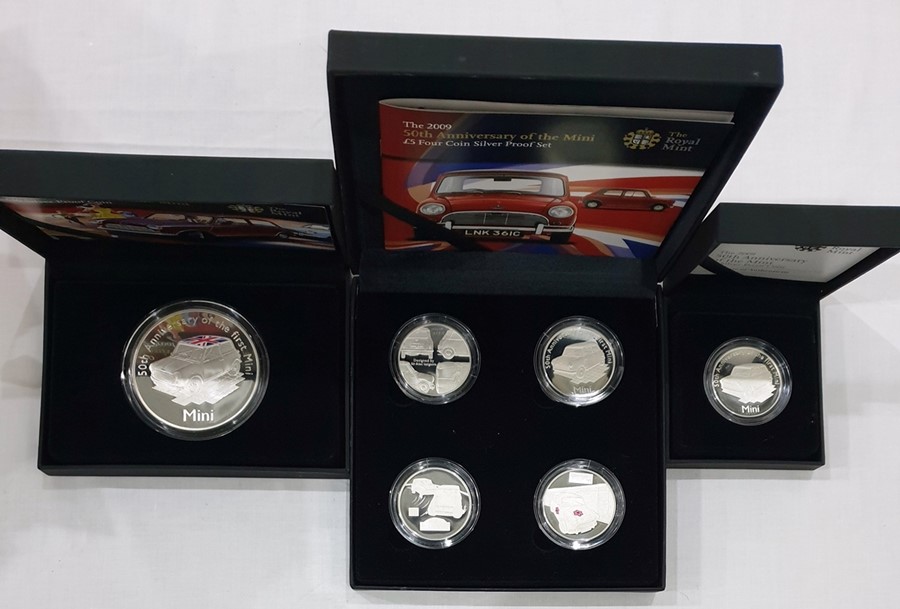 Collection of 50th anniversary Mini car, to include 1 x £5 solid silver coin, 4 x solid silver £5