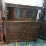 20th century oak reproduction court cupboard with two leaded glazed doors to the upper section above