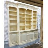Yellow painted bookcase in the Georgian manner with moulded pediment above the break front, with
