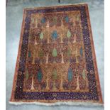 Rust and blue rug featuring stylised pear and other fruiting and flowering trees with a royal blue