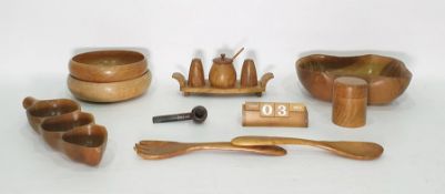 Wooden desktop calendar and a collection of carved bowls, table utensils, etc
