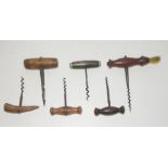 Six assorted 19th century corkscrews including one with rosewood handle and brush end, another