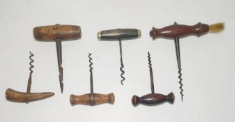 Six assorted 19th century corkscrews including one with rosewood handle and brush end, another