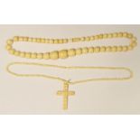 Bone necklace, graduated beads and an ivory-coloured crucifix pendant with necklace