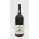 Bottle of Taylors 1975 vintage port, label is complete, wax capsule top is damaged but present