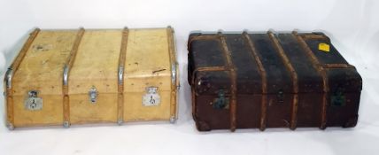 Two steamer trunks, one in a cream leather and wood-bound, the other brown leather and wood-bound (