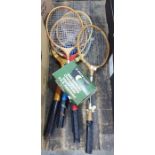 Four vintage badminton rackets and a wood framed tennis racket in press plus three squash balls