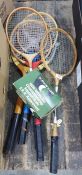 Four vintage badminton rackets and a wood framed tennis racket in press plus three squash balls