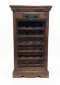 20th century wine rack in Eastern hardwood with single drawer above wine racks, plinth base, 54cm