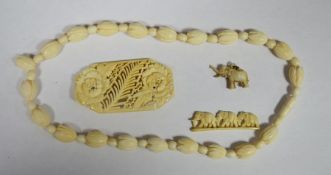 Ivory-coloured flowerbud and spherical bead necklace, bone miniature carving of elephants and two