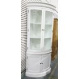 20th century white-painted bowfront corner display cabinet, the moulded cornice above two glazed