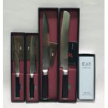Four boxed Japanese Shun kitchen knives and a whetstone