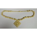 Ivory-coloured bead necklace in the form of miniature elephants alternating with honeycomb beads and