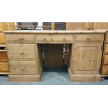 20th century pine dressing table with assorted drawers and cupboard doors, the whole raised upon a