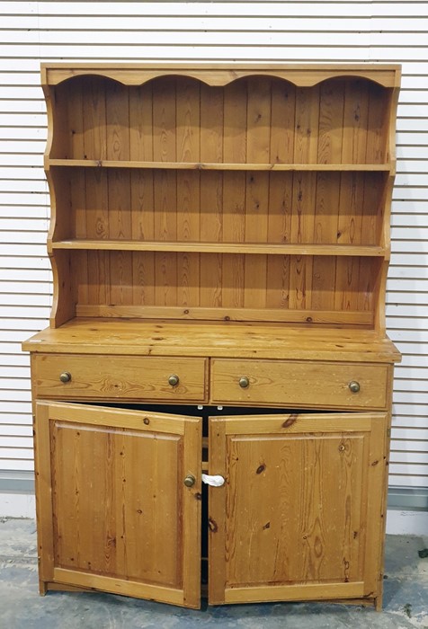 Pine dresser with open shelves above two drawers and two cupboard doors