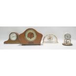 Modern quartz mantel clock with visible movement, a small Kundo anniversary clock and two other