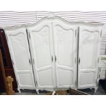White painted four-door armoire raised on cabriole supports, 220cm x 213cm