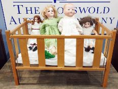 Four assorted dolls to include A M Green, SFBJ, Simon and Halbig and AM370, together with a cot