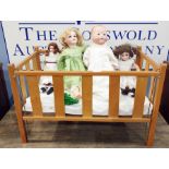 Four assorted dolls to include A M Green, SFBJ, Simon and Halbig and AM370, together with a cot