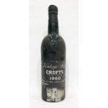 Bottle of Crofts 1960 vintage port, label is complete and wax capsule intact but damaged showing the