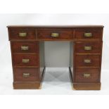 19th century mahogany desk with red leather inset top, nine assorted drawers, on plinth base,