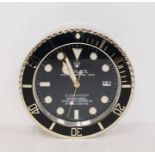 A Contemporary Rolex clock in the form of a submariner chronometer watch. Glows in the darkCondition