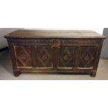 18th century oak coffer, the rectangular top with moulded edge, four front panels with diamond-