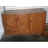 Light elm Ercol sideboard with two cupboard doors above single drawer with full length cupboard door
