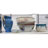 Four assorted ceramic wash basins, a chamber pot, a small dish and a blue and gilt glazed ewer by