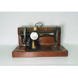 Gilt painted Singer sewing machine in mahogany box